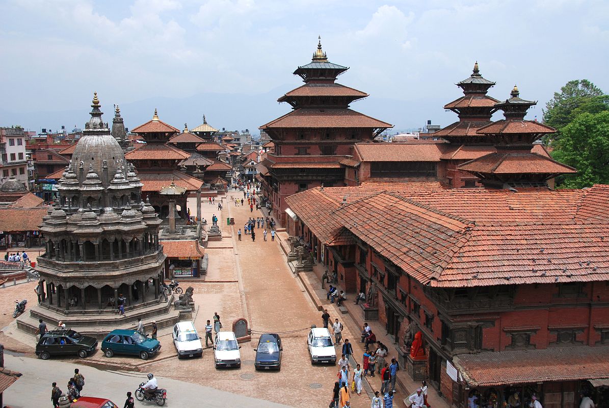 Kathmandu Patan Durbar Square 02 Krishna Temple, Taleju Bell, Hari Shankar Temple And Royal Palace The octagonal white stone Krishna Temple sits on the west side of Patan�s Durbar Square, while the whole eastern side is occupied by the Royal Palace. This view from the south was taken from the Teleju Restaurant.